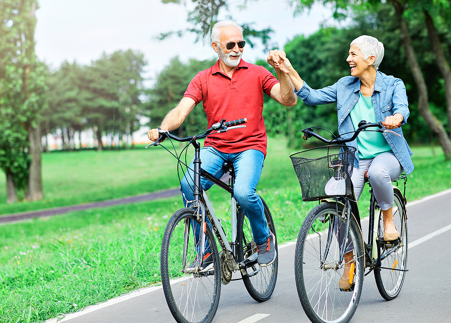elderly couple bicycling