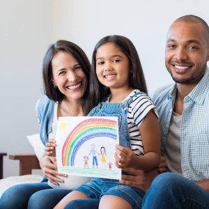 family with girl holding artwork symbolizing the child adoption process in Texas.