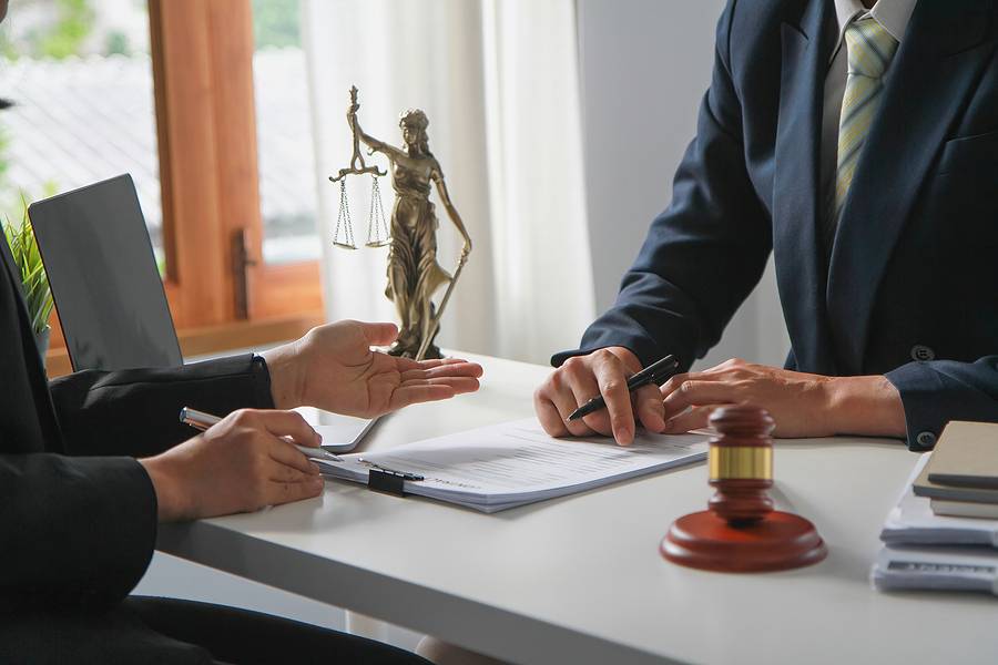 lawyer talking with client about how owning a business can affect child support